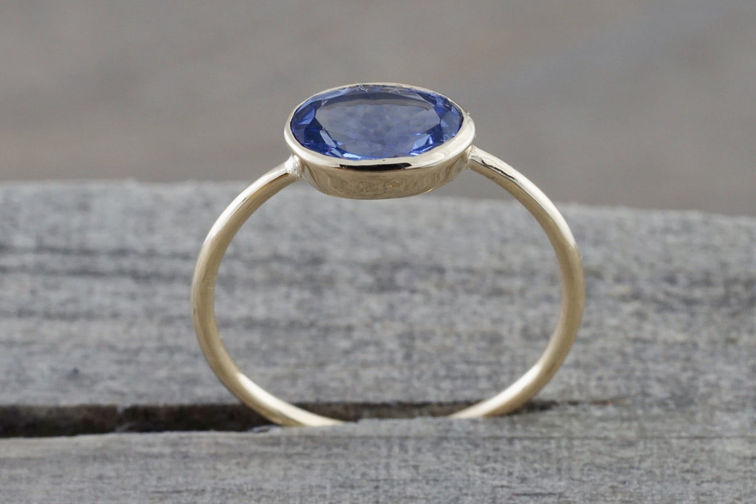 0.80 Carats Exotic Tanzanite is set on Solid 14k Yellow Gold Oval Bezel Band Ring - Brilliant Facets